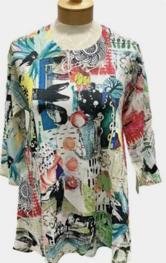 White Round Neck, Short Sleeve Knit Top w/Multi Colored Garden Print and Hi-Lo Hem by Inoah.