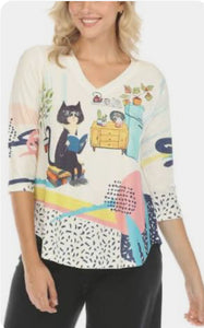 White V-Neck, Short Sleeve Knit Top w/Multi Colored Print and Cute Mr. Rodger’s Cat Scene by Inoah.